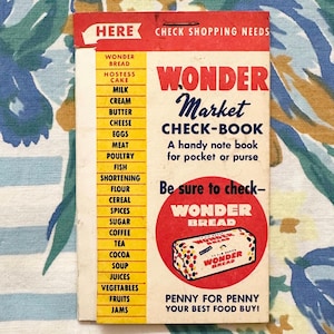 May include: A vintage "Wonder Market Check-Book" with a red and white design. The cover lists grocery items and a "Wonder Bread" logo. The text reads "Penny for penny your best food buy!" on a floral patterned background.