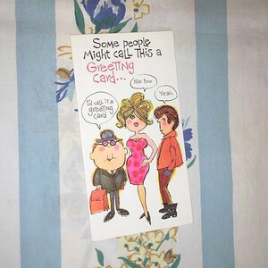 May include: A greeting card with a cartoon illustration of three people. The card reads "Some people might call this a Greeting Card... Me too. Yeah."