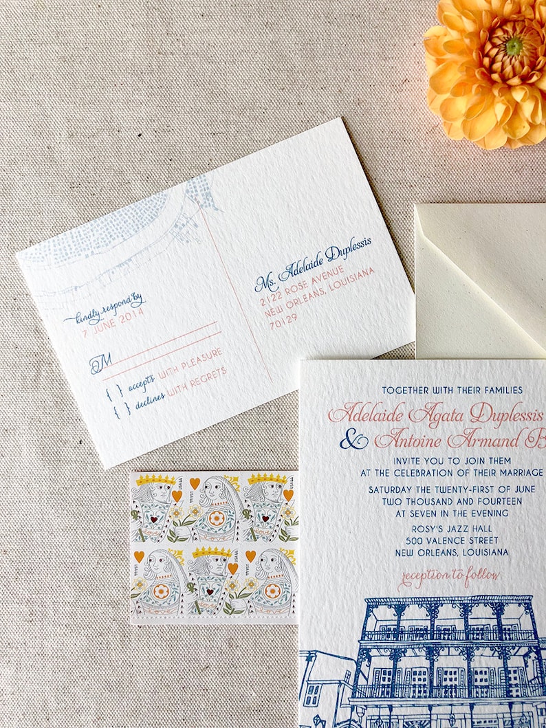 May include: Wedding invitation with a blue and white illustration of a building with balconies. The invitation is for Adelaide Agata Duplessis and Antoine Armand F. The invitation states the wedding will take place on Saturday, June 21, 2014 at 7:00 PM at Rosy's Jazz Hall in New Orleans, Louisiana.