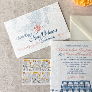 May include: Wedding invitation with a blue and white illustration of a building in New Orleans, Louisiana. The text reads "In the City of New Orleans We look forward to Celebrating with you!" and "Adelaide Agata Duplessis & Antoine Armand F. Invite you to join them at the celebration of their marriage Saturday the twenty-first of June two thousand and fourteen at seven in the evening Rosy's Jazz Hall 500 Valence Street New Orleans, Louisiana reception to follow."