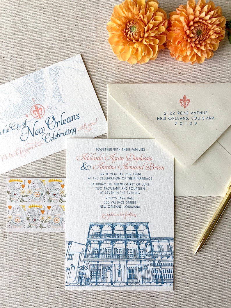 May include: Wedding invitation with a blue and white illustration of a building in New Orleans. The invitation is for Adelaide Agata Duplessis and Antoine Armand Brion, and the wedding will be held at Rosy's Jazz Hall on June 21, 2014 at 7:00 PM.