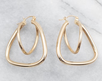 May include: A pair of gold-toned hoop earrings with a double-loop design. The earrings are made of a smooth, shiny metal and have a simple, elegant style.