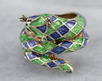 May include: A gold ring shaped like a coiled snake with green and blue enamel. The snake's scales are detailed with a diamond pattern.
