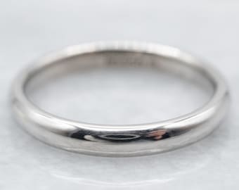 May include: A simple, polished silver wedding band.