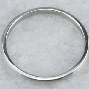 May include: A plain silver wedding band with a smooth, rounded surface.