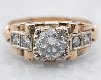 May include: A vintage engagement ring with a large, round, brilliant-cut diamond set in a gold band. The band is decorated with smaller diamonds and has a textured design.