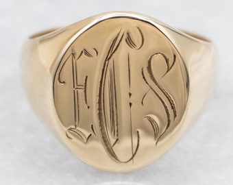 May include: A gold signet ring with an engraved monogram of the letters "E.S."