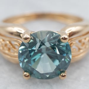 Yellow Gold Blue Zircon Solitaire Ring with Filigree Shoulders, A25146