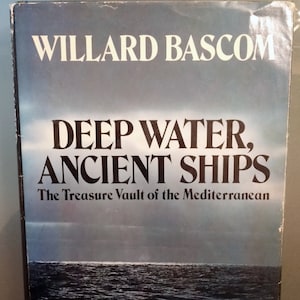 May include: A book cover with the title "DEEP WATER, ANCIENT SHIPS" by Willard Bascom. The cover features a dark, moody image of the ocean under a cloudy sky. The subtitle reads "The Treasure Vault of the Mediterranean."