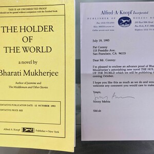 May include: An advance proof copy of the novel "The Holder of the World" by Bharati Mukherjee. The book cover is yellow with black text. The text includes the title, author's name, and publication details. The cover also features the Alfred A. Knopf logo.