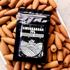 May include: A black package of "Gingerbread PPL Incense Cones" with a black and white graphic of a boat and waves, surrounded by many brown incense cones. The cones are cone-shaped and have a light brown color.