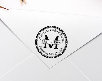 Puede incluir: Un sobre blanco con un sello de dirección de devolución personalizado en blanco y negro. El sello presenta el texto "7727 Lake Underhill Road", "Matthews", "Powood MS 39232" y una letra "M".