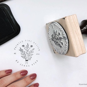 Custom rubber stamp for logos and branding. Wood mounted with laser engraved image on top and a walnut handle for easy use. Pictured is a 3x3 inch custom stamp with a handle