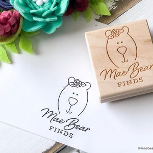 Custom rubber stamp for logos and branding. Wood mounted with laser engraved image on top. Pictured is a 2x2 inch stamp