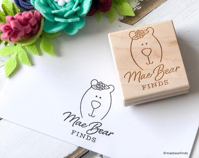 Custom rubber stamp for logos and branding. Wood mounted with laser engraved image on top. Pictured is a 2x2 inch stamp