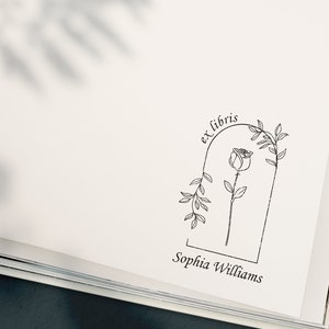 May include: A black and white illustration of a rose with leaves in an arch with the text "ex libris" above and "Sophia Williams" below.
