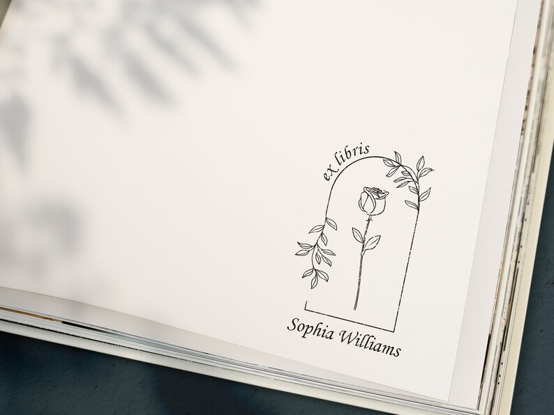 May include: A black and white illustration of a rose with leaves in an arch with the text "ex libris" above and "Sophia Williams" below.