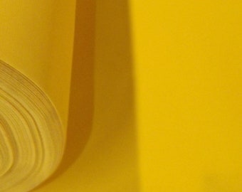 May include: A roll of bright yellow felt fabric.