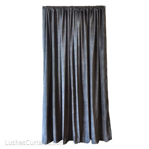 May include: A dark gray velvet curtain backdrop for photography or stage productions. The curtain is made of a soft, luxurious fabric and has a smooth, even texture.