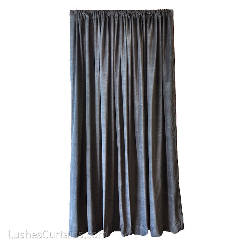 May include: A dark gray velvet curtain backdrop for photography or stage productions. The curtain is made of a soft, luxurious fabric and has a smooth, even texture.