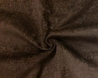Könnte beinhalten: Nahaufnahme eines braunen Stoffes mit einer strukturierten Oberfläche. Der Stoff hat einen dezenten Glanz und ein leicht raues Gefühl.