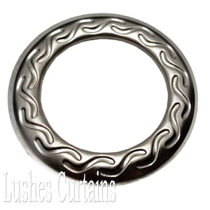 May include: Silver metal curtain ring with a decorative wave pattern around the edge.