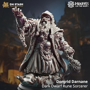 May include: A dark dwarf rune sorcerer miniature figure, painted in a grey and brown color scheme. The figure is wearing a hooded robe and holding a chain with a skull attached. The figure is standing on a base of ice crystals. The text "Dorgrid Darnane Dark Dwarf Rune Sorcerer" is printed below the figure.