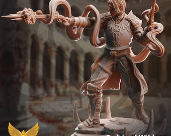 May include: A 3D printed miniature of a fantasy character, Cedric of Wildern, Soldier of Redemption. The figure is posed with a pistol in one hand and a glowing, multi-pronged weapon in the other. The figure is wearing armor and a flowing cape.