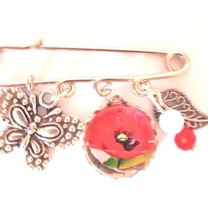 Fancy poppy cabochon brooch. Stainless steel.