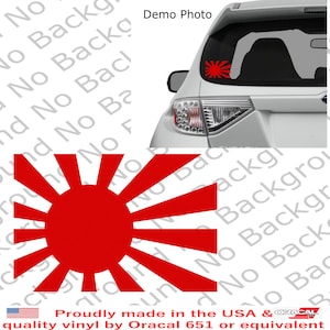 May include: Red vinyl decal of a rising sun with 16 rays. The decal is on the back window of a silver car. The text "Proudly made in the USA & ORACAL quality vinyl by Oracal 651 or equivalent" is at the bottom of the image.