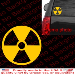 May include: A yellow and black radiation warning symbol decal. The decal is on a black car. The text "Demo photo" is visible on the car.