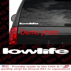 May include: White vinyl decal with the text "lowlife" in a 3D style. The decal is shown on the back window of a black SUV. The text "Demo photo" is written in red below the decal.
