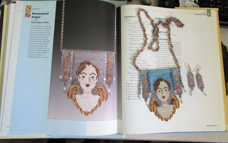 May include: A beaded necklace and earring set featuring a portrait of a woman with angel wings. The necklace and earrings are made with blue, orange, and white beads. The text "Homeward Angel" is visible.