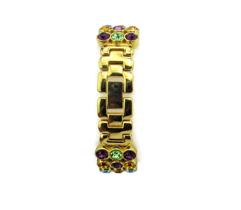 May include: A gold-tone bracelet with a chain link design and colorful crystal accents.