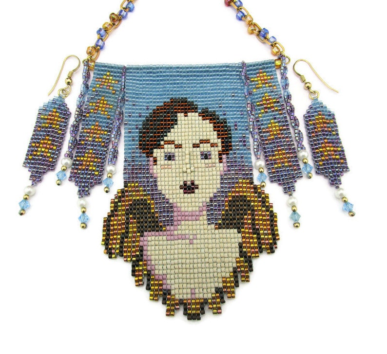 May include: A beaded necklace and earring set featuring a portrait design. The necklace has a light blue background with a pixelated face and wings. The earrings and necklace have gold, blue, and purple beads with dangling accents.