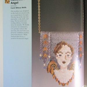 May include: A beaded necklace featuring a portrait of a woman with glasses, framed by a rectangular design with orange and purple accents. The necklace is suspended from a gold chain. The text "Homeward Angel" is visible.