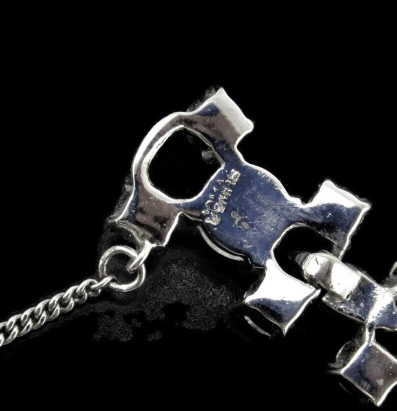 Puede incluir: Pulsera de tono plateado con cadena y un amuleto de logotipo entrelazado caracter&iacute;stico. El amuleto tiene la inscripci&oacute;n "Salvatore Ferragamo" en la parte posterior.