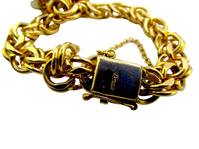 May include: Gold chain bracelet with a clasp that reads "American Jewelry".