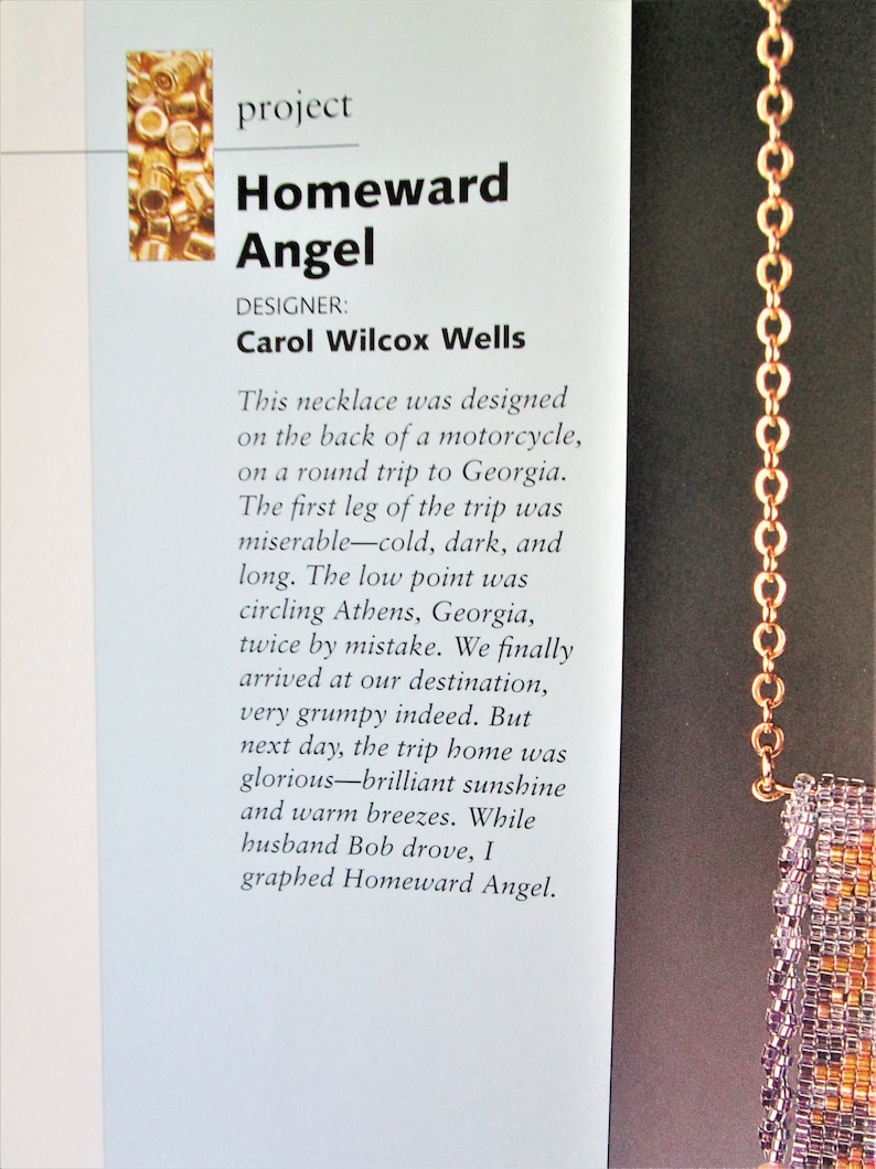 May include: A close-up of a beaded necklace with a gold chain. The necklace has a rectangular pendant with a mix of orange, purple, and gold beads. The text on the page reads "Homeward Angel" and "Carol Wilcox Wells."