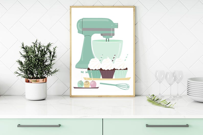 May include: A mint green stand mixer with a bowl and cupcakes. The cupcakes are decorated with frosting and sprinkles. There are also small round candies on a tray.