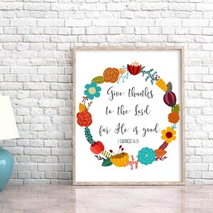 May include: A printable wall art design featuring a floral wreath with colorful flowers and leaves. The wreath surrounds the text "Give thanks to the Lord for He is good" with the scripture reference "1 Chronicles 16:34".