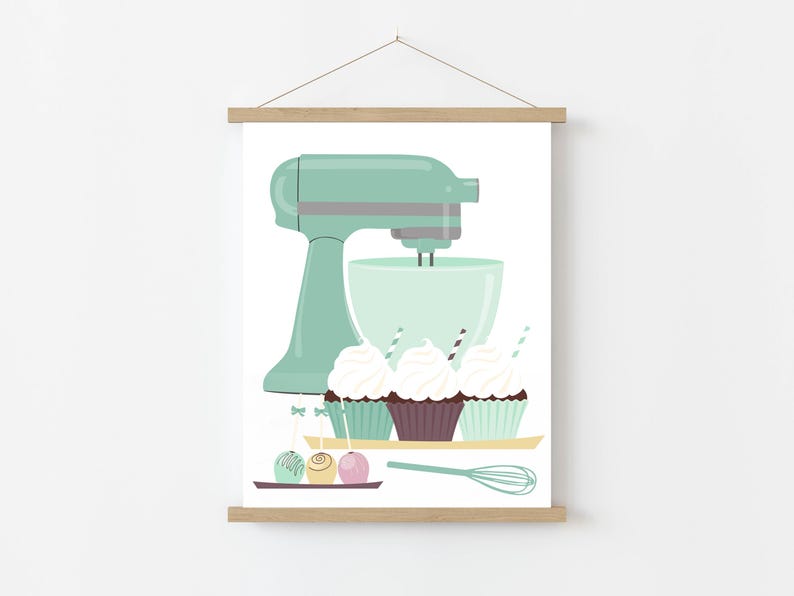 May include: A mint green stand mixer with a bowl and a whisk attachment. Three cupcakes with white frosting and sprinkles are in front of the mixer. There are also three round cake pops with colorful sprinkles.