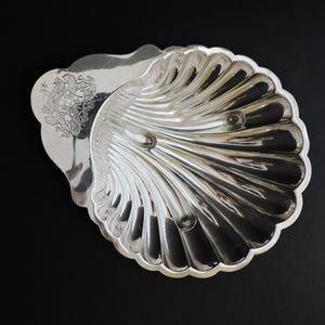 May include: A set of three ceramic mugs with a speckled, matte finish. The mugs are in shades of cream, light gray, and dark gray. Each mug has a simple, minimalist design and a rounded handle.