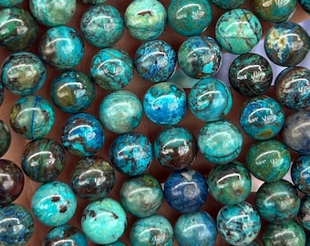 May include: A close-up of numerous spherical beads in teal, turquoise, and brown hues. The beads display a marbled effect, with diverse colours and patterns. These gemstone beads are suitable for jewellery making.