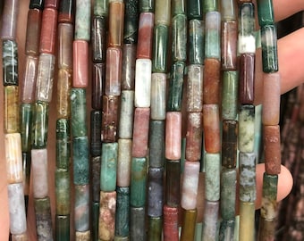 May include: A strand of colorful agate gemstone beads. The beads are cylindrical and have a variety of patterns and colors, including green, brown, red, and white.