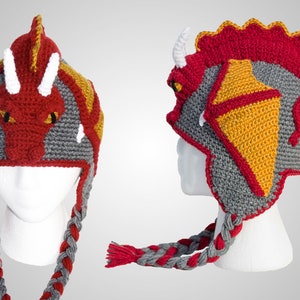 May include: Red, gray, and yellow crocheted dragon hat with a long braided tail.