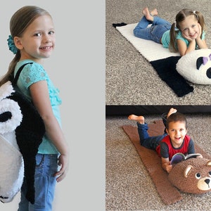 May include: Two children are using a crocheted panda and bear pillow rug. The panda rug is black and white with a pink bow. The bear rug is brown. Both rugs have a long, flat body and a head with a face.