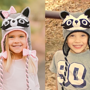 May include: Two children wearing gray and black raccoon hats with long ties. The girl's hat has a pink bow on top and pink and gray ties. The boy's hat has black ties.