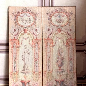 May include: Two rectangular panels with a vintage, ornate design. Each panel features a central figure, one a statue and the other a fountain, framed by columns and floral garlands. The colour palette includes soft pinks, creams, and touches of gold, evoking a classical aesthetic.