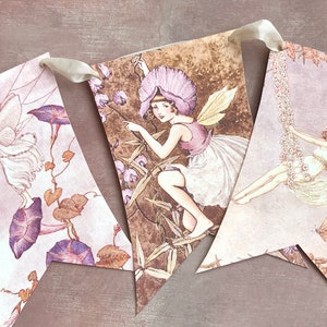 May include: A set of four vintage-style fairy themed paper pennants. Each pennant features a different fairy illustration with delicate wings and floral details. The pennants are connected with a white ribbon.